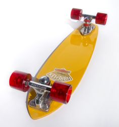 a yellow skateboard with red wheels on a white background