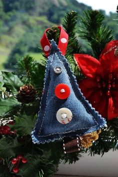 an ornament made out of jeans and buttons sits on a window sill