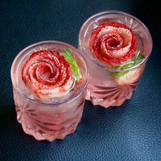 two glass cups filled with food on top of a table