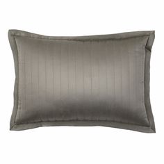 a gray pillow with pleated edges and a satin lining on the front, sitting against a white background