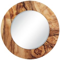 a round mirror sitting on top of a wooden table