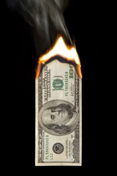 a burning money bill with the words monetary policy on it