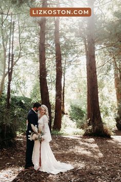 a bride and groom standing in the woods for their wedding photo session at lizkoston com