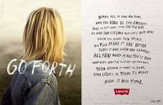 a woman standing in front of a white brick wall with the words go forth written on it