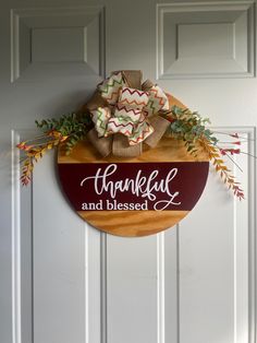 a wooden sign hanging on the side of a door that says, thanksgiving and blessing