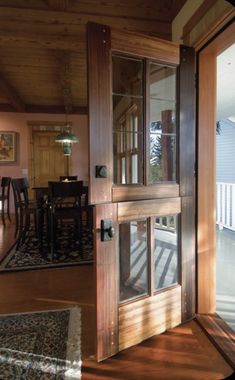 an open door leading to a dining room and living room with sliding glass doors on both sides