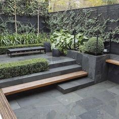 an outdoor garden with benches and plants