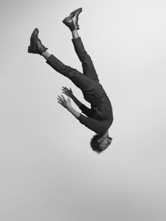 a man flying through the air while riding on top of a skateboard with his feet in the air