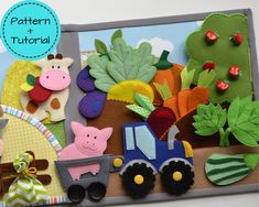 a close up of a craft board with farm animals and vegetables on the front, along with an image of a tractor