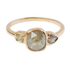 a gold ring with three stones on it