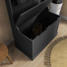 an open shoe box sitting on top of a wooden floor next to a chair and rug