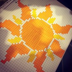 an orange and yellow pattern is shown on top of a notepad that has been drawn