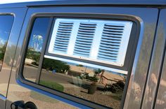 the side view mirror of a vehicle with an air vent on it's side