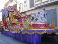 there is a float that has been decorated with gold, purple and white decorations on it