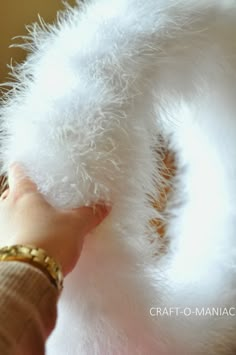 a person holding a fluffy white object in their hand