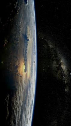 the earth is seen from space with stars in the sky and clouds on it's side