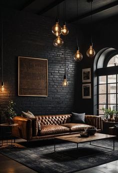 a living room with black walls and leather couches, hanging light bulbs over the fireplace