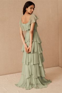 a woman in a long green dress