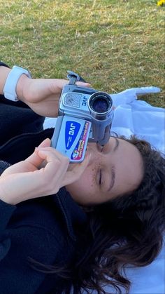 a person laying on the ground with a camera