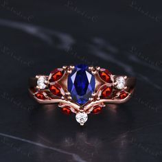 a blue and red ring with diamonds on it