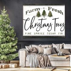 a christmas tree is in front of a black wall with a white sign that says, farm fresh christmas trees pine spruce cedar fir