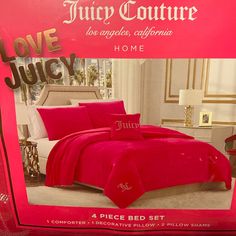 a red bed in a box with the words juicy couture on it