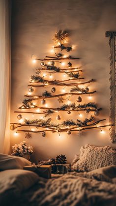 Wall-mounted driftwood Christmas tree with warm lights and ornaments Tree Out Of Lights On Wall, Wall Hanging Christmas Tree Ideas, Wall Tree With Lights, Stick Wall Christmas Tree, Driftwood Christmas Tree Wall Hanging, Christmas Tree Wall Decor Ideas, Twig Wall Christmas Tree, Diy Wall Hanging Christmas Tree