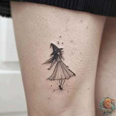 a woman's thigh with a little witch tattoo on her left side ribcage