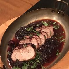 some meat and vegetables in a pan on a table