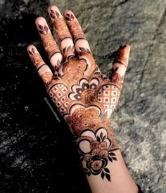 a woman's hand with henna on it