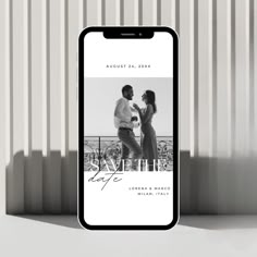 a cell phone with an image of two people standing next to each other and the text save the date on it