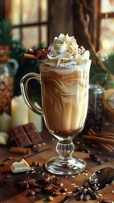 a glass cup filled with hot chocolate and whipped cream