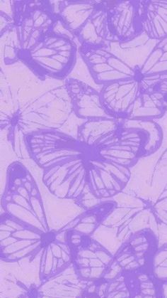 a bunch of purple butterflies flying in the air