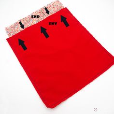 an end - to - end red cloth with two black arrows pointing towards each other