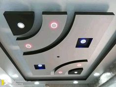 the ceiling is decorated with black and white circles, lights, and round holes in it