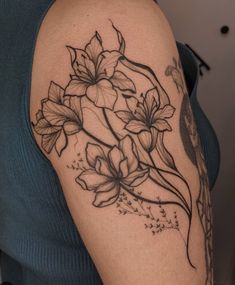 a woman's arm with flowers on it