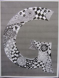 the letter g is made up of black and white designs on gray paper with an abstract pattern