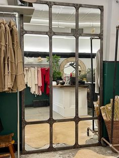 a large mirror sitting on top of a wooden floor