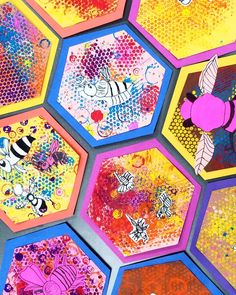 colorful hexagons with bees and honeycombs painted on them