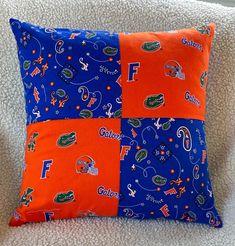 an orange and blue pillow with florida gators on it