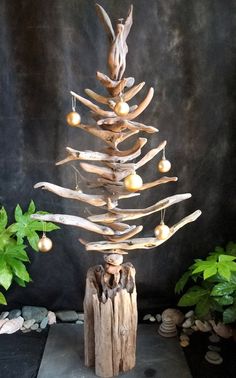 a christmas tree made out of driftwood and balls