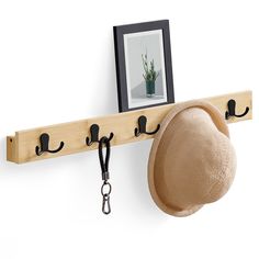 a hat is hanging on a coat rack with hooks