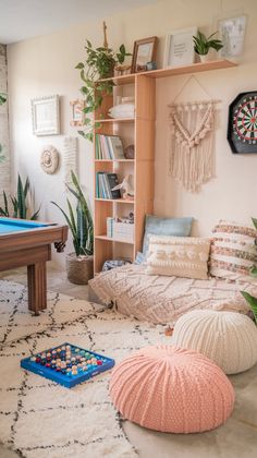 a living room filled with lots of furniture and decor on top of a white rug