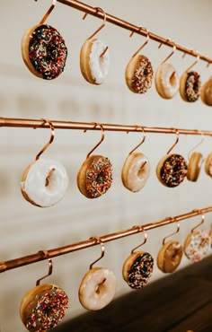 donuts are hanging on the wall with hooks