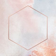 a hexagonal gold frame on a pastel pink and blue background with some white speckles