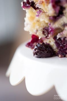 a close up of a piece of cake with cranberry toppings on it