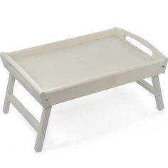 a small white wooden tray with handles on the top and bottom, sitting on a white background