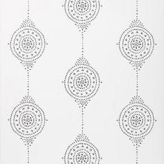 a white wallpaper with black dots and circles in the middle, on top of it