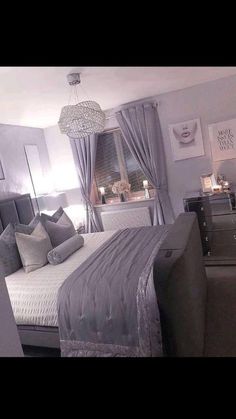 a bedroom with a bed, dressers and pictures on the wall above it's headboard