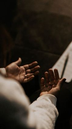 two people reaching out their hands to touch each other